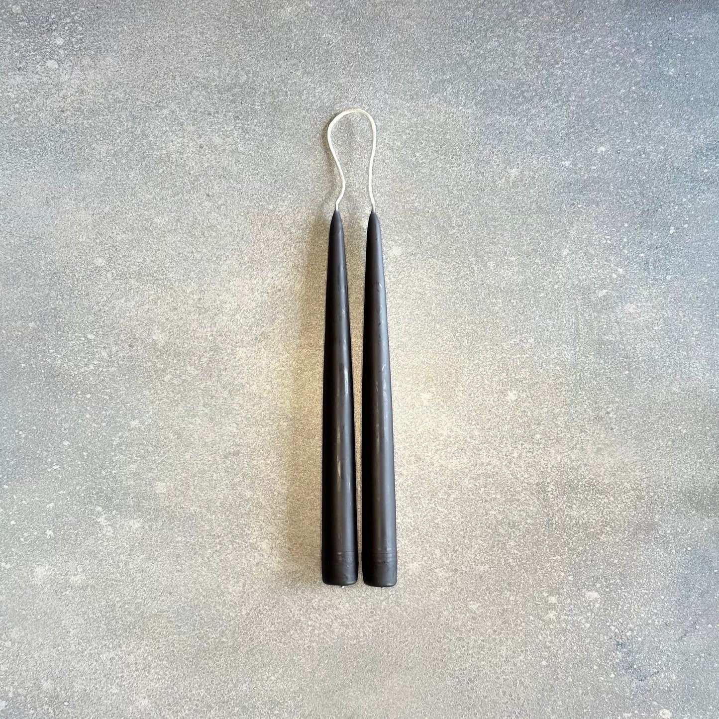 A pair of DANICA DESIGNS HAND-DIPPED TAPER CANDLES creating a stunning display at Gestalt Haus.