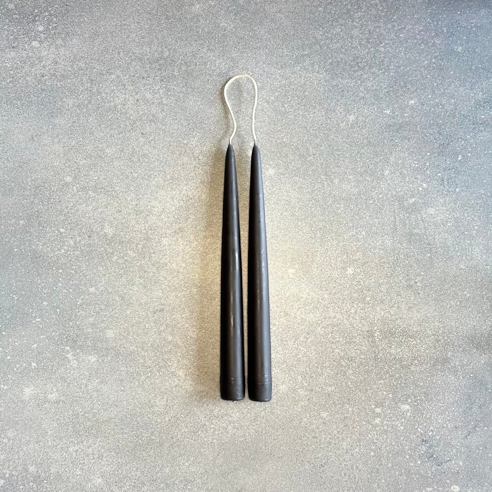 A pair of DANICA DESIGNS HAND-DIPPED TAPER CANDLES creating a stunning display at Gestalt Haus.